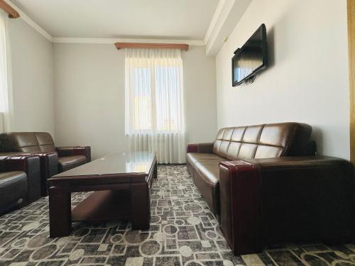 a waiting room with a couch and a table and chairs at SD Hotel in Yerevan