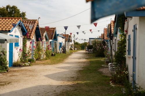 a street of colourful houses in a village at Camping La Pointe du Médoc in Le Verdon-sur-Mer