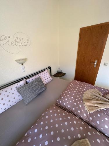 a bedroom with a bed with polka dots at Ferienhaus Löwenherz in Pommern