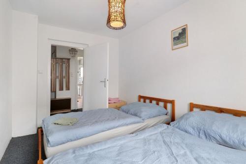 a bedroom with two beds and a mirror at Yellow in Miltenberg