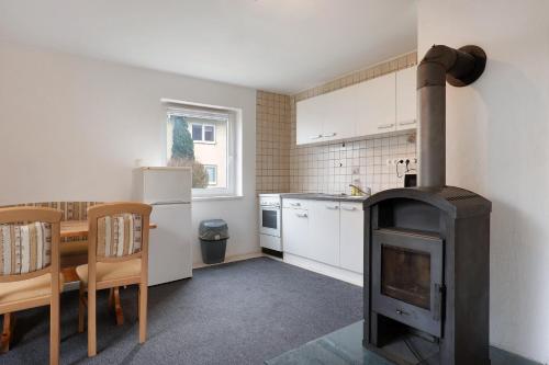 a kitchen with a wood stove in a kitchen with a table at Yellow in Miltenberg