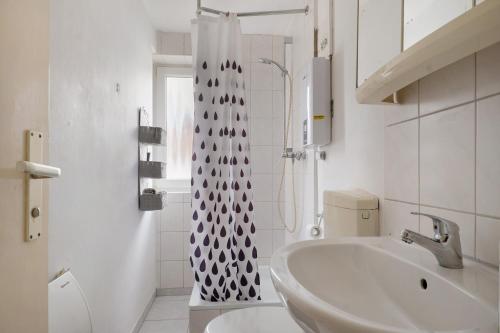 a white bathroom with a sink and a shower at Yellow in Miltenberg
