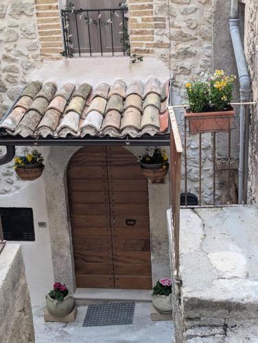 an entrance to a building with a wooden door at Charming Mountain Retreat in Pacentro, Italy in Pacentro