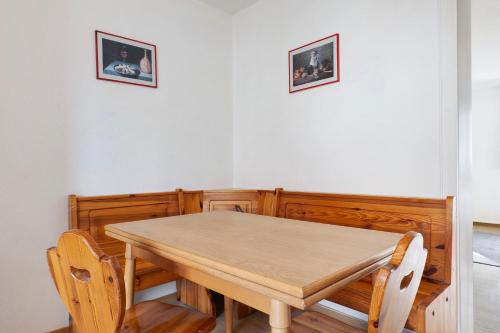 a dining room table with two pictures on the wall at Yellow in Miltenberg