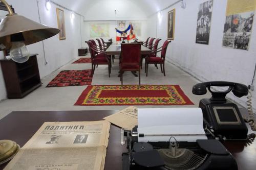 a room with a table and chairs and a telephone at Hotel Royal Drina in Mali Zvornik