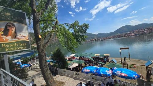 a beach bar with a view of the water at Hotel Royal Drina in Mali Zvornik
