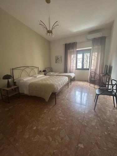a bedroom with two beds and a chandelier at La Magnolia - Rooms in Verona