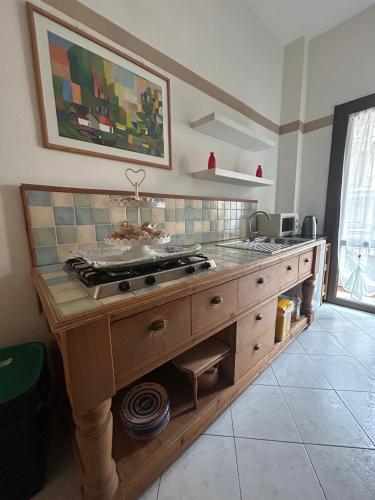 a kitchen with a stove top on a wooden island at La Magnolia - Rooms in Verona