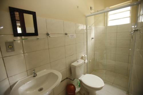 a bathroom with a toilet and a shower and a sink at Apoena Chales da Ilha in São Francisco Xavier