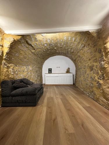 a living room with a couch and a stone wall at Arc Home apartment in Agrigento
