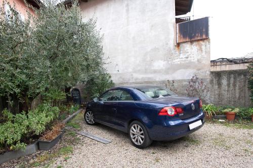 a blue car parked in front of a building at appartamento Monika con parcheggio in Volano