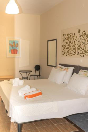 a bedroom with a large white bed with towels on it at Mouse House in Gouvia