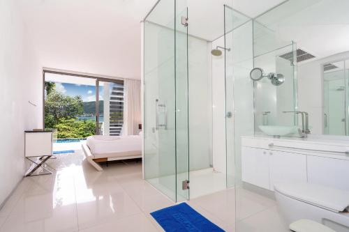 a bathroom with a glass shower and a sink at Atika Villa 7 ocean view pool villa in Patong Beach