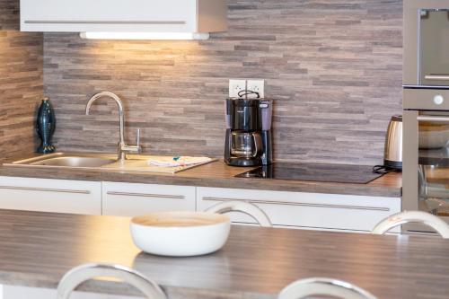 a kitchen with a sink and a counter top at Rêve Bleu, 2 p, vue mer panoramique in Penmarcʼh