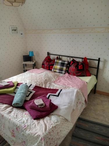 a bedroom with a bed with clothes on it at Hankas Biodling in Silverdalen
