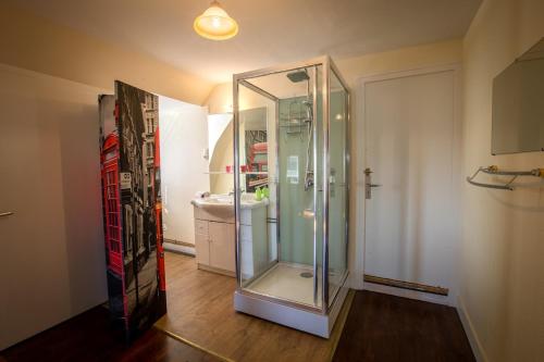a glass shower in a bathroom with a sink at Gite Charlotte au Domaine de la Morétie in Cublac
