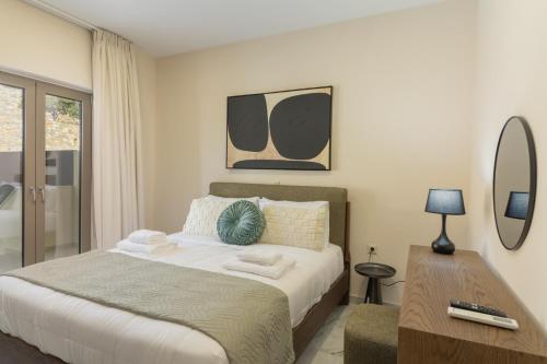 a bedroom with a large bed and a table at Elysian Villas - With 2 Private Pools in Roumelí
