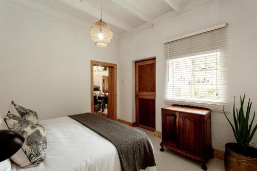 a bedroom with a bed and a window at Double Story at 55 in Graaff-Reinet
