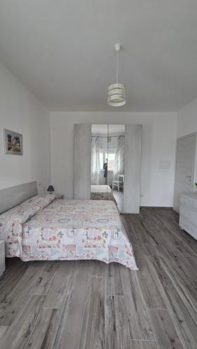 a bedroom with a large bed and a wooden floor at Stanze Del Mare - Sea Rooms in Otranto