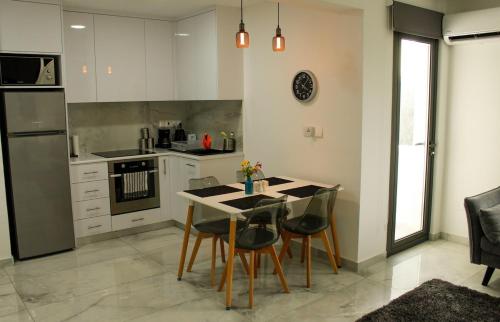 a kitchen with a table and chairs in a room at Mediterranean Apartments 1 in Paphos City