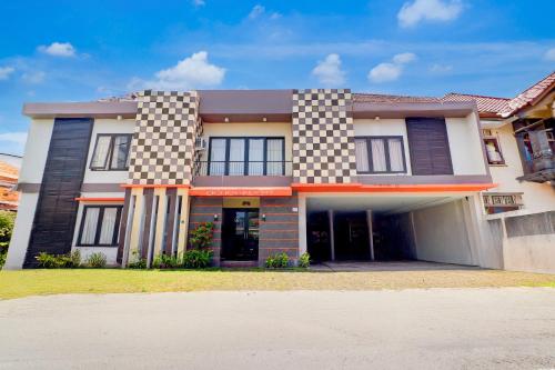 デンパサールにあるCollection O Near Bali Royal Hospital Renon Formerly JC Boutique Hotelの市松模様の家