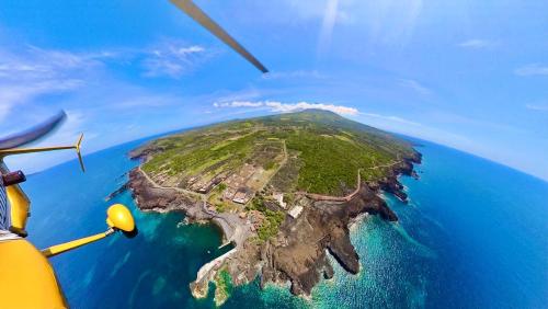 an island in the ocean from a helicopter at Casa do Guardião in Madalena