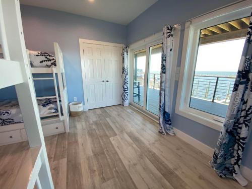 a bedroom with two bunk beds and a large window at Kokomo Sands in Hatteras