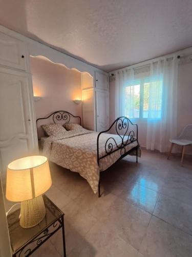 une chambre avec un lit et une table avec une lampe dans l'établissement Appartement confortable 70m2 au pied du Canigó, à Codalet