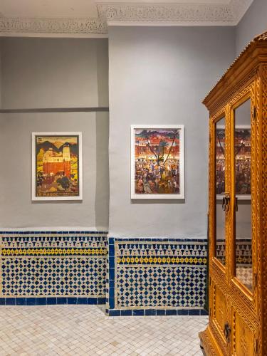 a room with blue walls with paintings on the wall at RIAD TANJA by chef Moha in Tangier