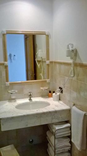 a bathroom with a sink and a mirror at Riviera Residence in Marina di Pietrasanta