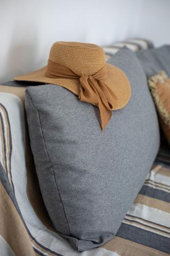 a hat is sitting on top of a bed at Avra 3 modern apt by the sea in Tsoútsouros