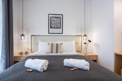 a bedroom with a bed with two towels on it at Avra 3 modern apt by the sea in Tsoútsouros