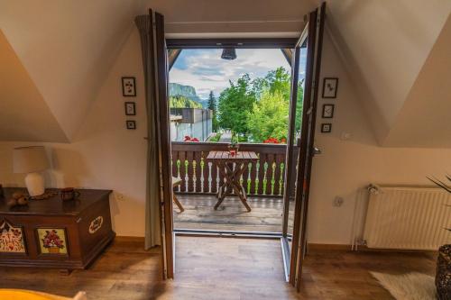 a glass door leading to a patio with a table at UpArt Bled in Bled