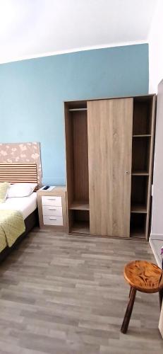 a bedroom with a bed and a table and a stool at Madeirarooms in Funchal