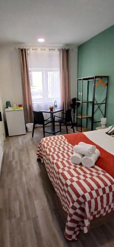 a bedroom with a bed and a table with chairs at Madeirarooms in Funchal