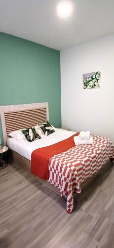 a bedroom with two beds with a red and white blanket at Madeirarooms in Funchal
