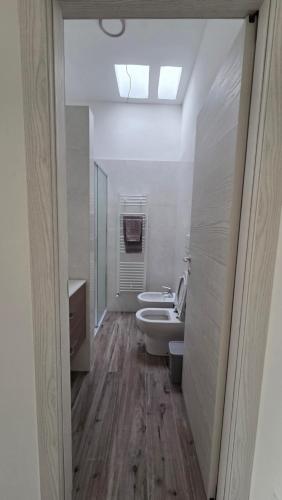 a bathroom with two sinks and two toilets in it at Stanze Del Mare - Sea Rooms in Otranto