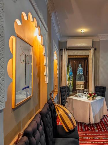 a dining room with a table and a couch at RIAD TANJA by chef Moha in Tangier