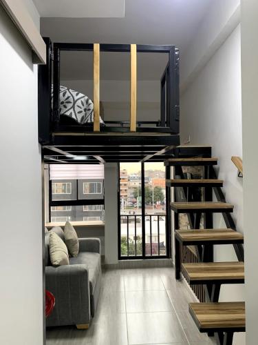 a living room with a loft bed and a couch at Apartment in La Castellana in Bogotá