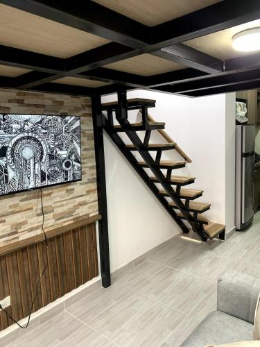 a staircase in a living room with a tv at Apartment in La Castellana in Bogotá
