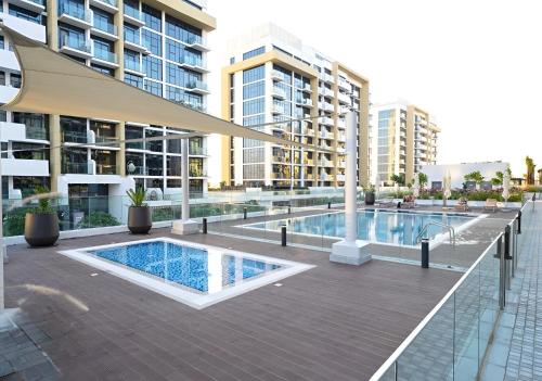 a swimming pool in the middle of a building at Roomook Apartments in Dubai