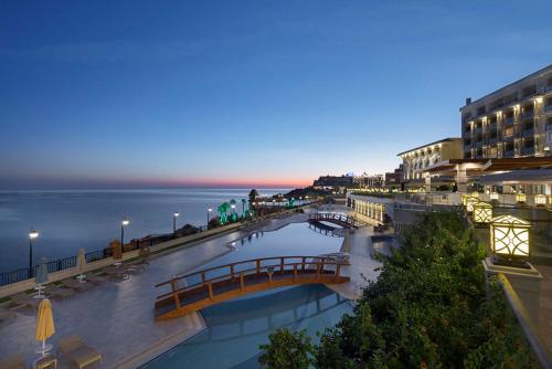 a bridge over a body of water in a city at Merit Royal Premium Hotel Casino & SPA in Kérynia