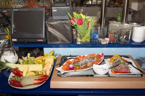 a table with two plates of food on a table at Hotel Sonne am Meer in Norddeich