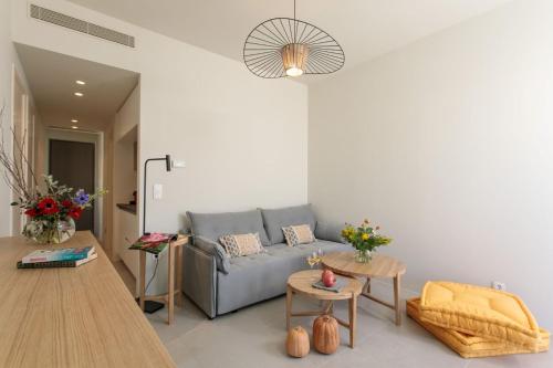 a living room with a couch and a table at Summer Sense, New Private Retreat with Private Pool, Agia Anna, Naxos in Agia Anna