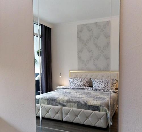 a bedroom with a bed with a mirror in it at Apartment Regina am schönen Möhnesee in Möhnesee