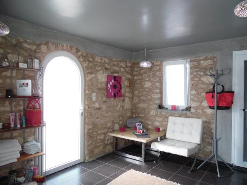 a room with a table and a chair and a window at Villa Daba in Ghazoua