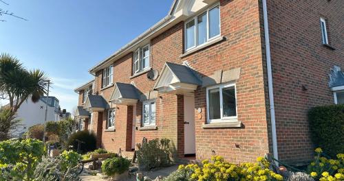a red brick building with a lot of windows at Chalkhill View - Idyllic Sea Views Parking in Wyke Regis