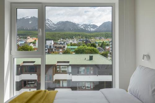 a room with a window with a view of a building at Casa Cima in Ushuaia