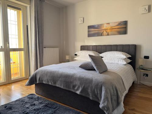 a bedroom with a large bed with white sheets and pillows at Casa Cecilia, Natura & Relax in Villanova dʼAsti