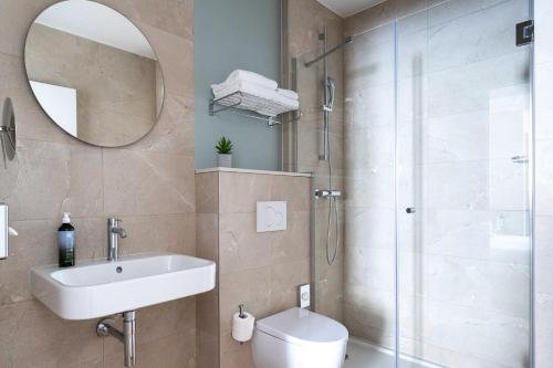 a bathroom with a shower and a sink and a toilet at Hotel Acadia - Astotel in Paris